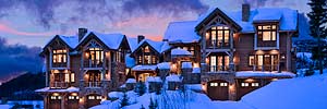 exterior elevation at twilight of luxury rustic condominiums at The Yellowstone Club mountain resort