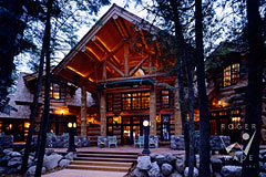 luxury handcrafted log home lodge patio at twilight