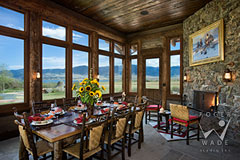 four season porch dining room with fireplace and views of luxury rustic Montana ranch