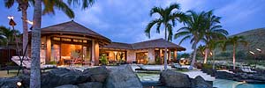 patio view at twilight of luxury Polynesian styled home with retractable walls