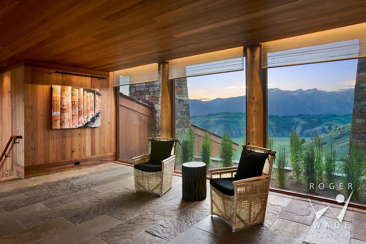 mountain modern interior design photography, entry in evening light, looking out windows to mountain view, jackson, wy