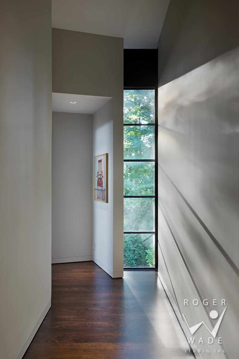 contemporary interior design photography, view from hallway to master bedroom with light streaming through windows, portland, or