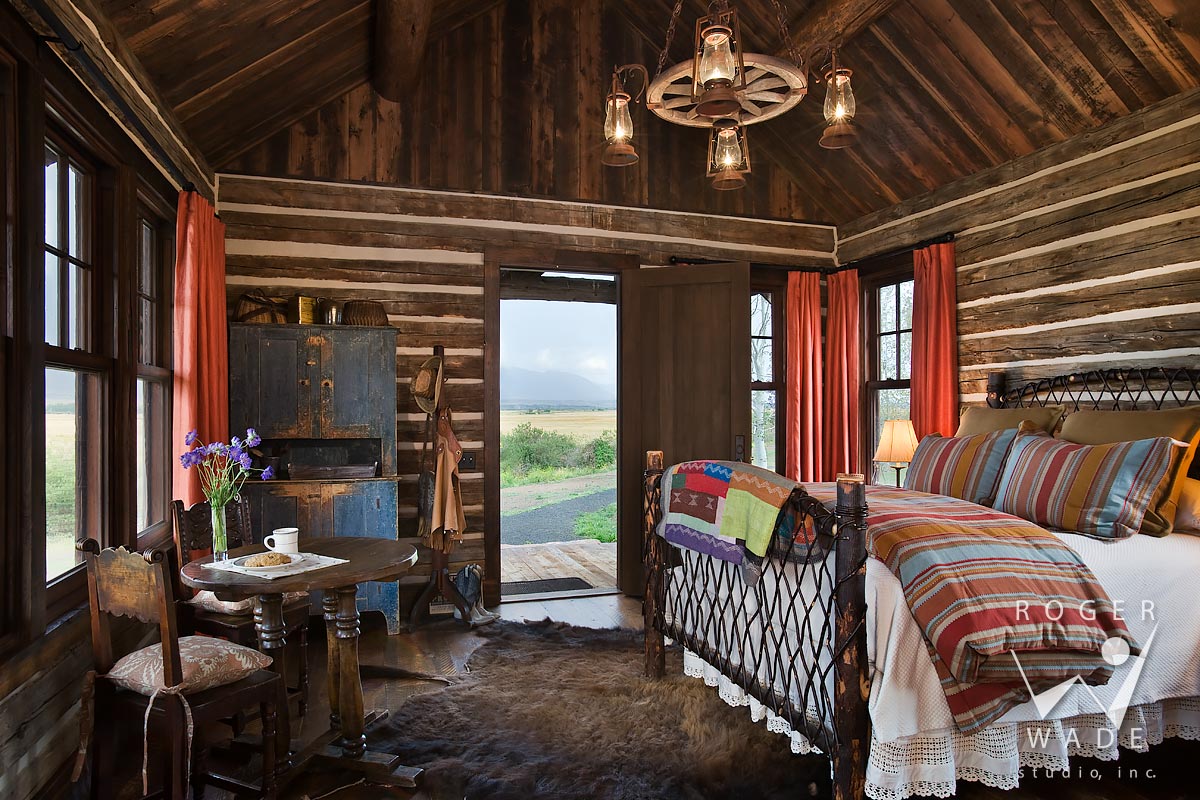log cabin photography, restored cabin toward bed, looking out door to ranch view, mcallister, mt