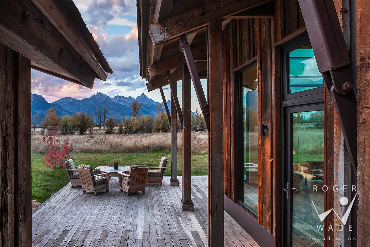 looking out to patio and mountain views at twilight through timber architecture, jackson, wy