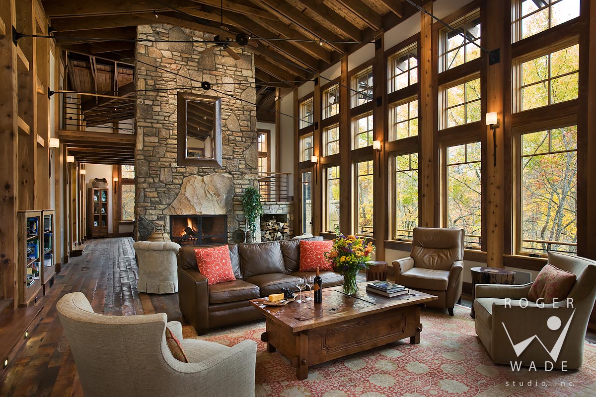 living room toward fireplace and windows looking out to fall color, balsam, nc