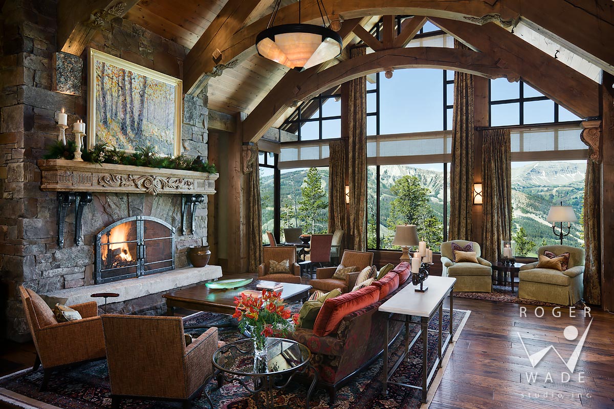 living room toward fireplace and windows looking out to mountain view, yellowstone club, mt