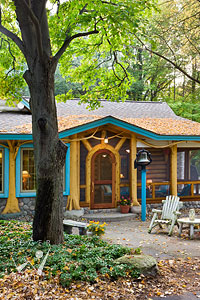 front entry of colorful handcrafted log cabin