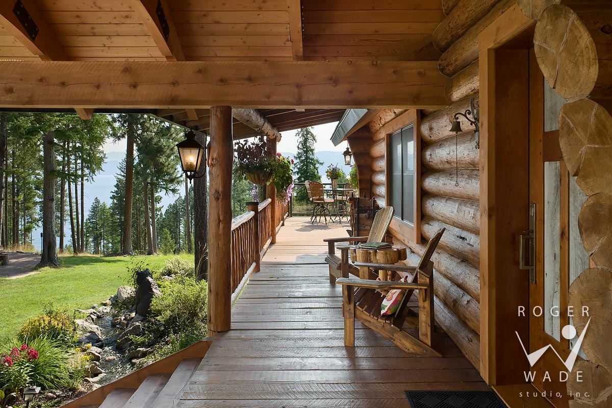 log home stock image, looking down front porch toward view of flathead lake, lakeside, mt