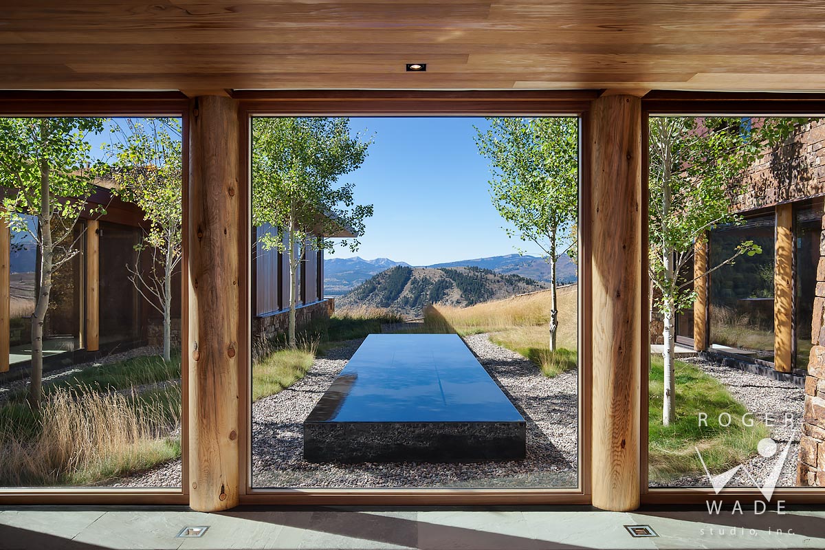 contemporary log home photo, view from foyer looking out to courtyard and mountain view, jackson, wy