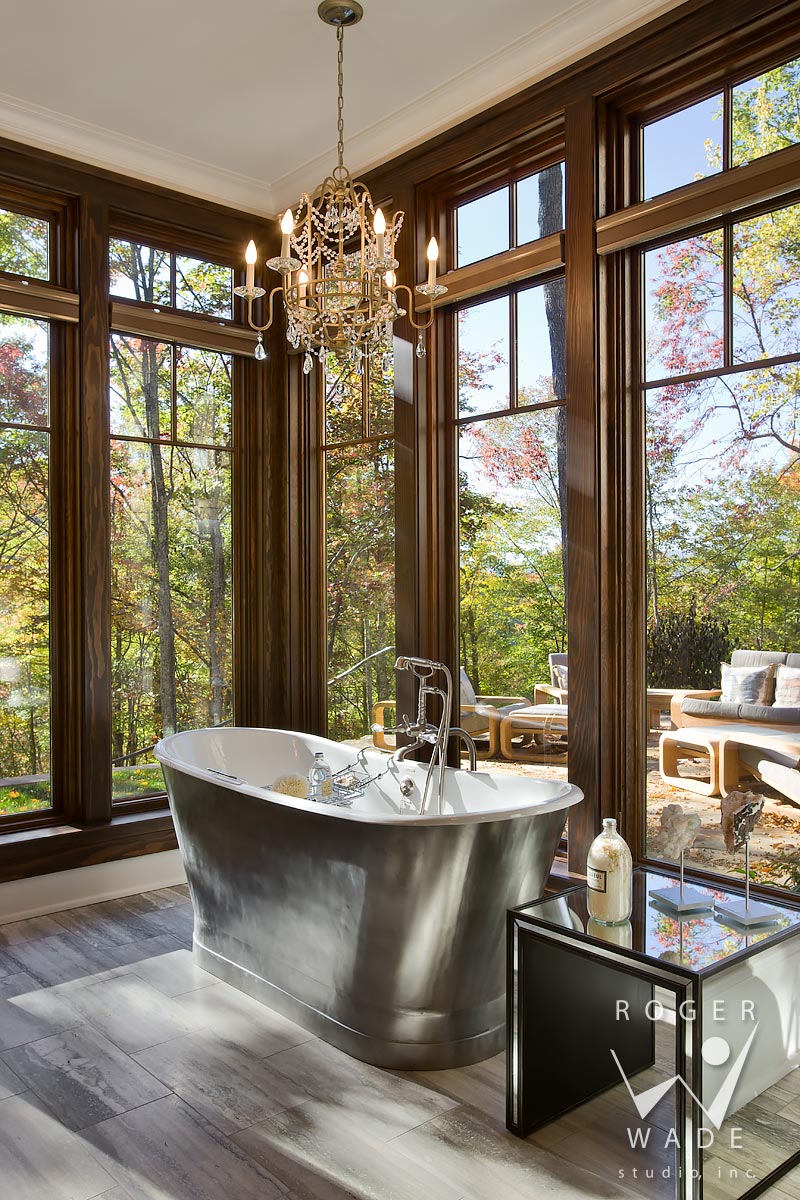 traditional interior photography of luxury bathroom tub looking out windows to fall color, balsam mountain preserve, nc