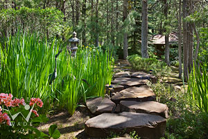stone pathway to bath house through iris garden for Architectural Digest