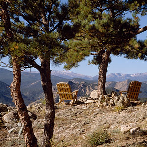 lifestyle scene of adirondack chairs perched atop a rocky Colorado mountaintop